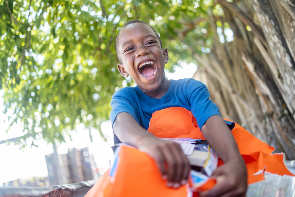 Boy opening a gift and smiling