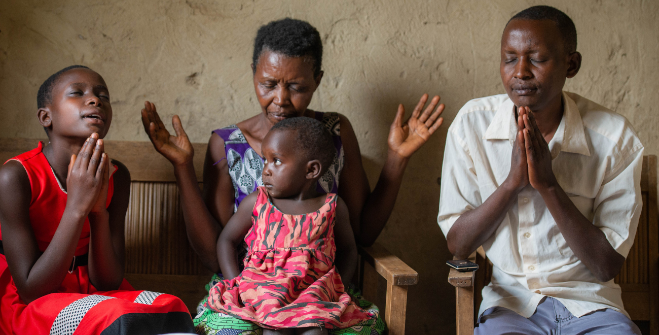 A family pray in Uganda