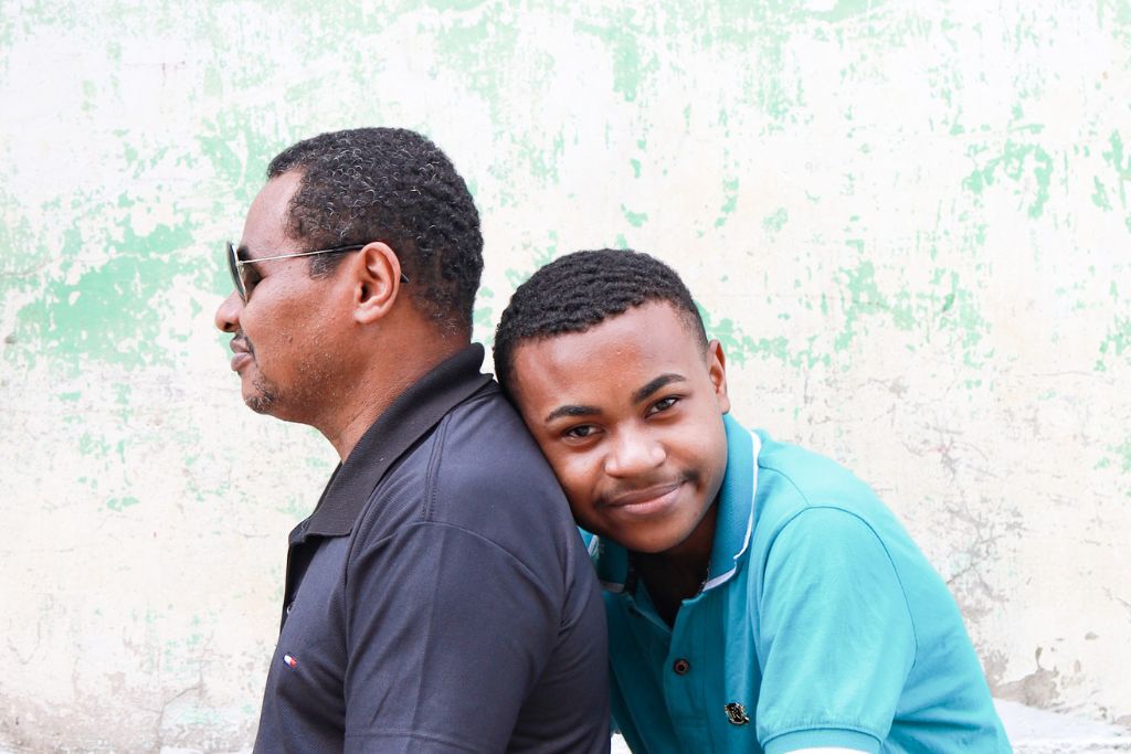 Marcelo leaning on back of dad